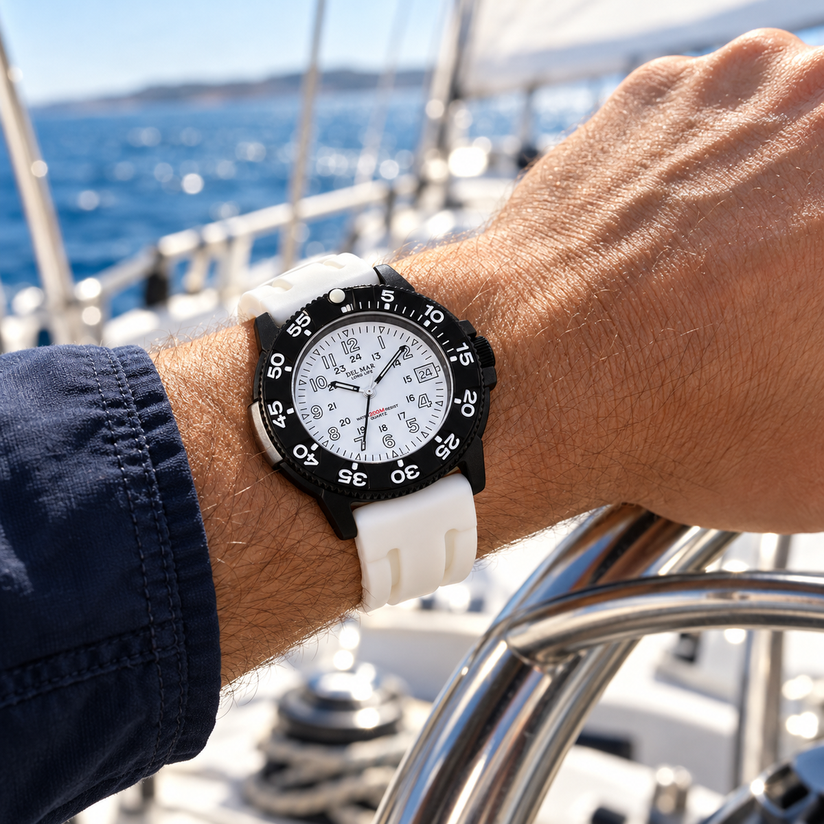 Del Mar Sand Key 50385 watch with a white dial and white sport strap, worn while sailing.